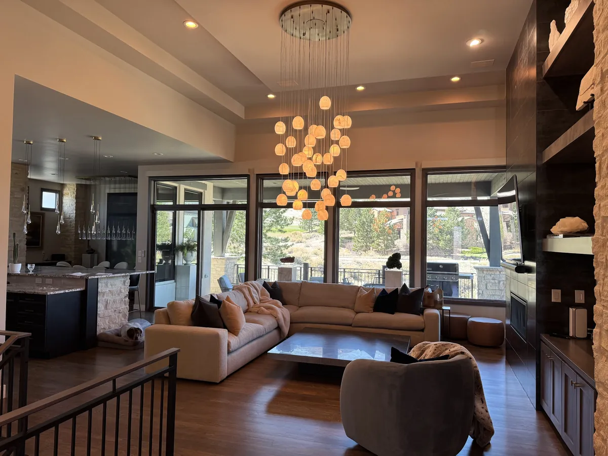 Great room with a cluster chandelier and recessed lights