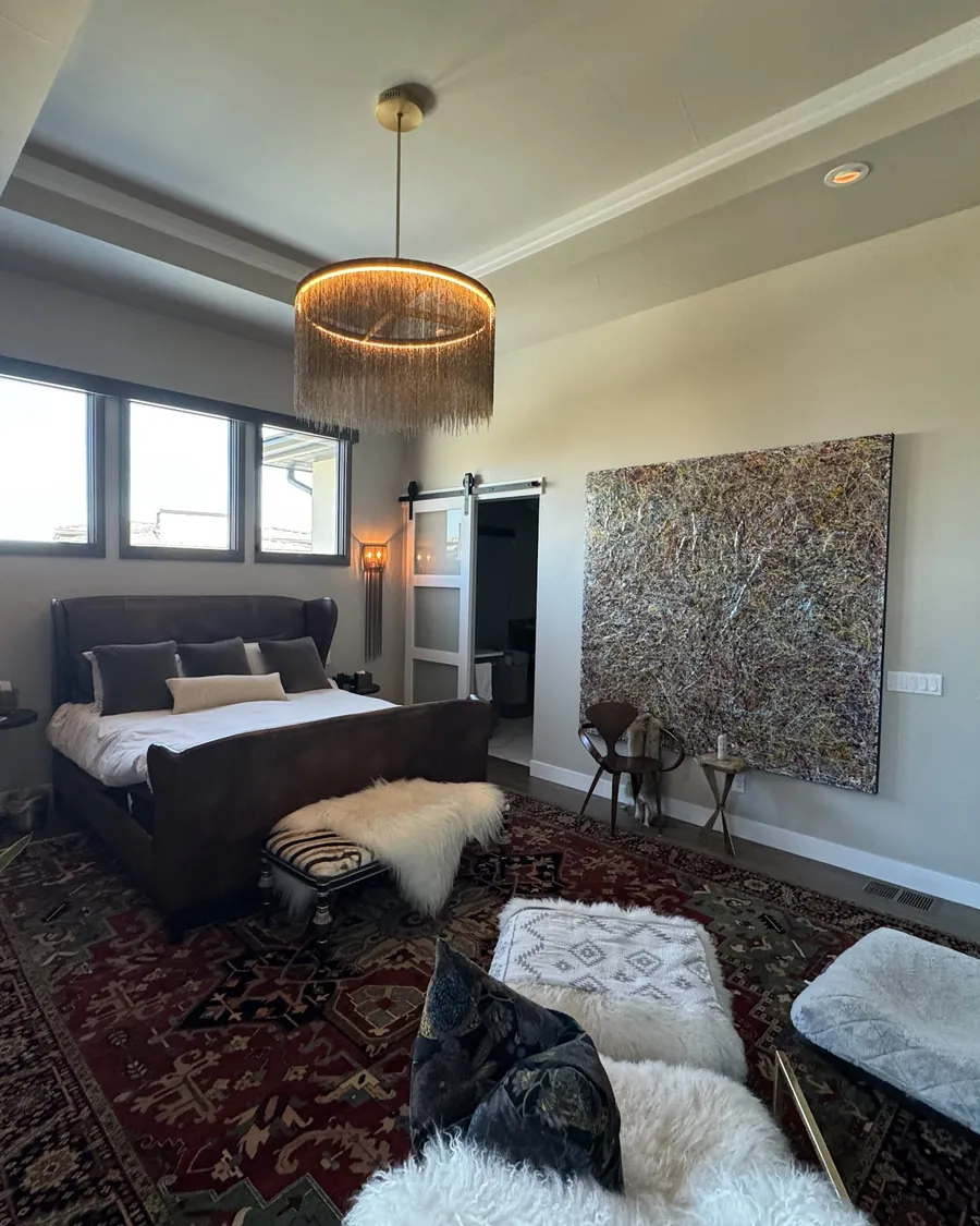 Bedroom with a large glowing ring pendant and recessed lights