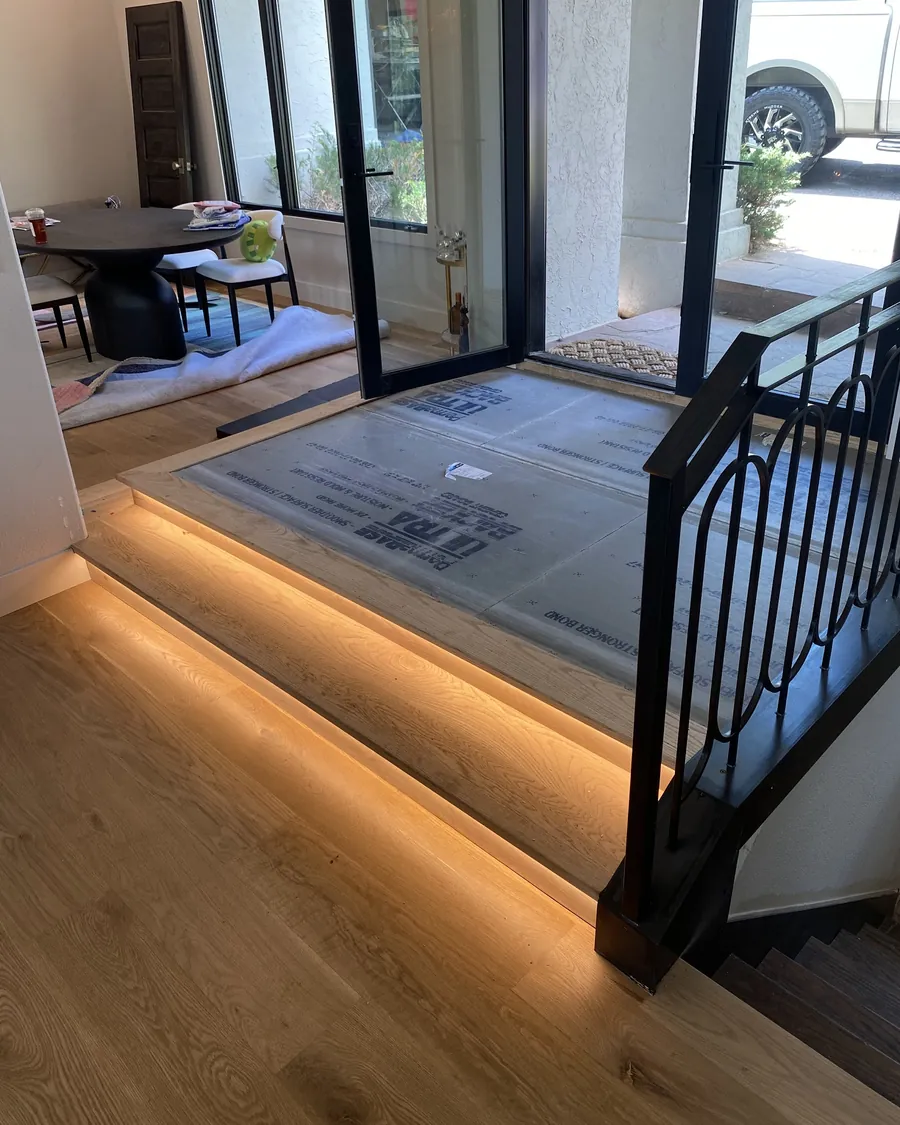 Entry landing with LED light washing the floor along the edge of the step